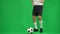 Unrecognizable Caucasian sportsman catching passing ball in slow motion on green screen. Young professional footballer