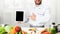 Unrecognizable Chef Guy Showing Tablet Screen Pointing Finger In Kitchen