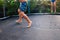 Unrecognizable children jumping on a trampoline with swimming trunks and enjoying their friends in a group