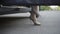 Unrecognizable confident slim Caucasian woman on high-heels walking out the car and leaving. Young gorgeous lady getting