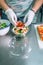 Unrecognizable cook preparing salad to takeaway