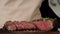 Unrecognizable Cook Seasoning Beef Steaks Sprinkling Salt In Kitchen, Closeup