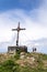 Unrecognizable couple standing in front of the religious cross on Sonntagskogel Mountain summit in Alps, Sankt Johann im Pongau
