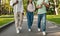 Unrecognizable diverse teen students walking in college campus after classes, walking together outdoors and talking