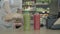 Unrecognizable female cashier checking out goods in grocery. Side view of young woman employee working in food shop