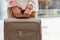 Unrecognizable female passenger holding suitcase posing at duty free international airport terminal