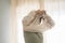 Unrecognizable female people wearing sweater getting ready at home - morning wake up adult woman with window light in background