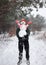 unrecognizable figure of man in snow holds in arms cheerful snowman in medical mask with smile painted on it