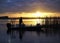 Unrecognizable Fisherman Moves His Boat into Position as the Sun Comes Up