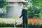 Unrecognizable Gardener Watering Colorful Flowering Plants in the Park