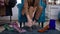 Unrecognizable gay man sitting in shoe shop with row of footwear thinking. Front view Caucasian LGBT person making