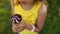 Unrecognizable girl eating italian ice cream cone smiling while resting in park on summer day