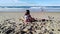 Unrecognizable girl playing with her toys on the beach