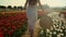 Unrecognizable girl running in tulip field. Young woman legs running in park.