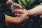 Unrecognizable grandmother and her granddaughter holding hand with love. Grandparents protection concept