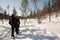 Unrecognizable group of people walking in a row with snow rackets