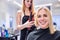 Unrecognizable hairdresser creating hairstyle for her beautiful