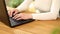 Unrecognizable hand female chatting online in social network using typing on laptop