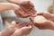 Unrecognizable hands holding rice, outstretching towards other people