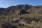 Unrecognizable hiker walking through a mountainous acenery in Mendoza, Argentina