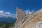 Unrecognizable hikers near a bizarre shaped rocky peak, Dolomites, Italy