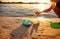 Unrecognizable kid playing with rubber duck toys on beach.