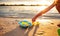 Unrecognizable kid playing with rubber ducks on seashore.