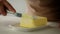 Unrecognizable Lady Cutting Butter In Slices Cooking In Kitchen, Cropped