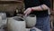 Unrecognizable latin artisan woman making clay vessels in her crafts workshop. Mapuche traditional handwork pottery