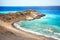 Unrecognizable lonely human figure on deserted beach