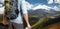 Unrecognizable Male Traveler With A Backpack Looking Into The Distance Mountains, Rear View. Adventure Destination Concept