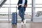 Unrecognizable Man Checking Boarding Time In Tickets While Standing At Airport Terminal