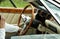 Unrecognizable man drives a retro car with a chic steering wheel