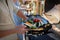 Unrecognizable man grilling vegetable on grill during family summer garden party, close-up.