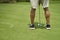 Unrecognizable man playing golf putting on green