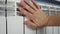 Unrecognizable man`s hand check for heat and touch central heating system