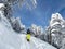 Unrecognizable man on ski touring adventure treks up a narrow snowy trail.