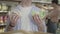 Unrecognizable man standing in grocery with cabbage and gingerbread cookies. Adult Caucasian buyer choosing between