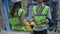 Unrecognizable man and woman passing blueprint shaking hands talking smiling standing in industrial storage indoors