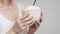 Unrecognizable Mature Lady Holding Coconut With Straw Over Gray Background