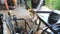 Unrecognizable mechanic grinding metal on his workplace. Worker cutting some detail using circular saw. View on desktop