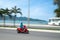 Unrecognizable motobike driver in front of the Beach near Nha Trang, Vietnam. Captured in motion, blurred. With a
