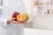 Unrecognizable nutritionist holding fresh fruit, copy space