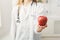 Unrecognizable nutritionist woman with apple