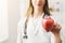 Unrecognizable nutritionist woman with apple