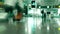 Unrecognizable passengers walk in generic airport terminal. Long exposure time lapse