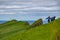 Unrecognizable people hiking to Mykines lighthouse in Faroe islands