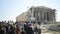 Unrecognizable people large crowd walking Parthenon monument tilt-shift