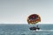 Unrecognizable people prepare on boat for parasailing, starting fly soon. Selective focus on parachute. Concept of vacation,