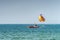 Unrecognizable people prepare on boat for parasailing, starting fly soon. Selective focus on parashute. Concept of vacation,